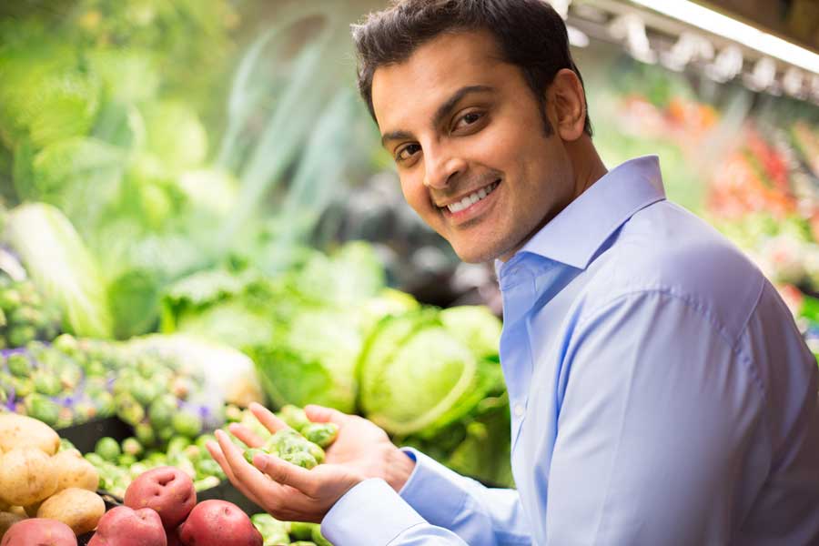 Choosing vegetables in grocery store