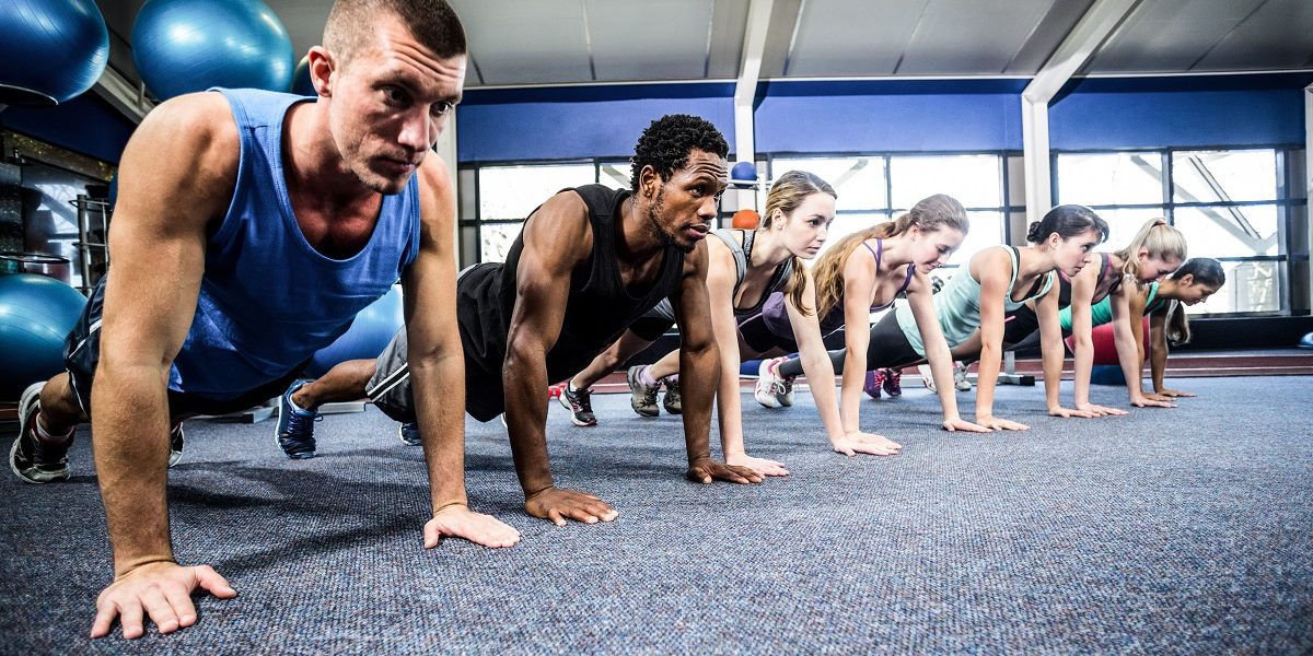 Fit people working out in fitness class Fit people working out in fitness class
