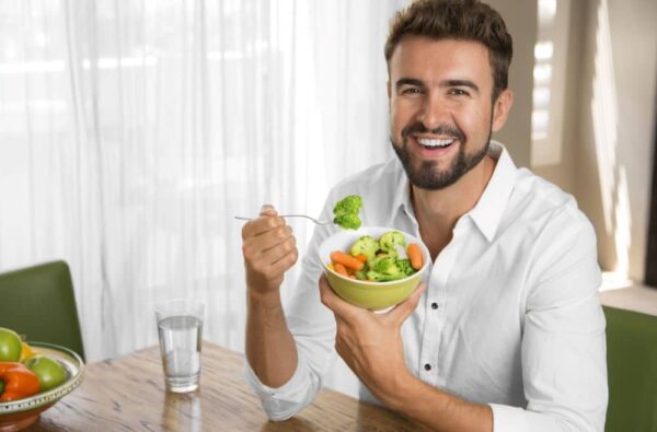 Man eating vegetables.