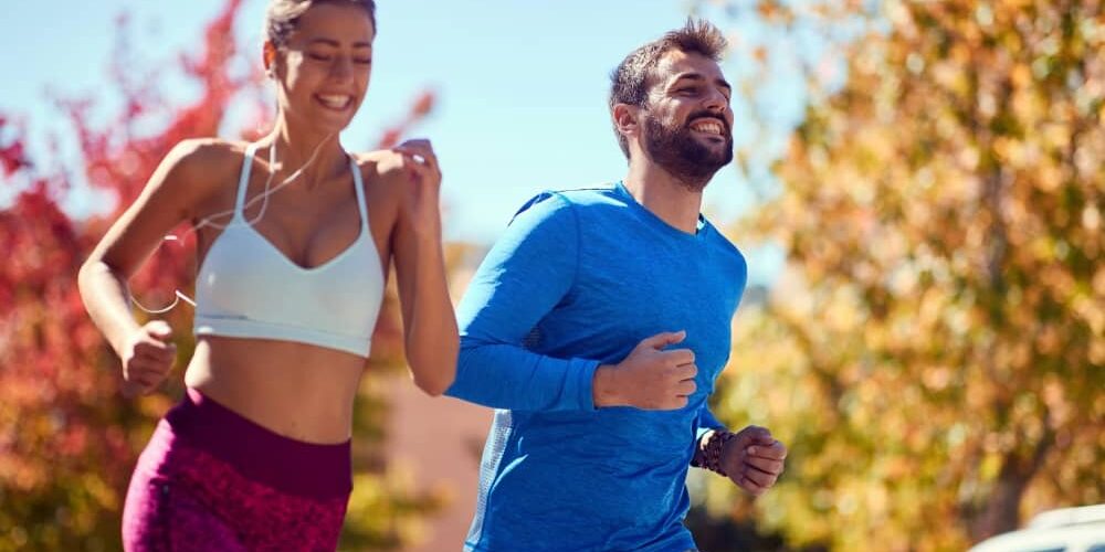 young-couple-jogging-outdoors An active lifestyle with adequate physical activity and exercise can really help to improve your health.